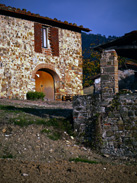 Stone house and well in the tuscan countryside in Italy