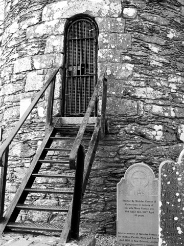 Stairs lead to a door of the tower at Monasterboice in Ireland.
