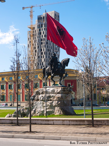 The Albanian flag flies over the Skanderbeg Monument in Tirana.