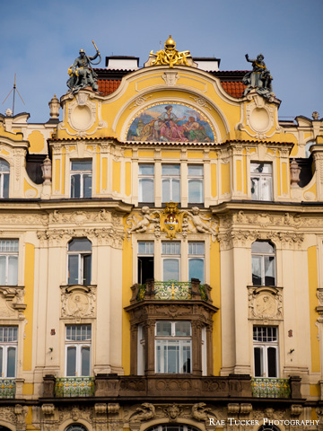 An ornate, yellow building in Prague, along the Old Town Square.