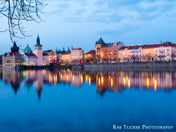 Early evening settles over the Vltava river and the skyline of Prague in the Czech Republic.