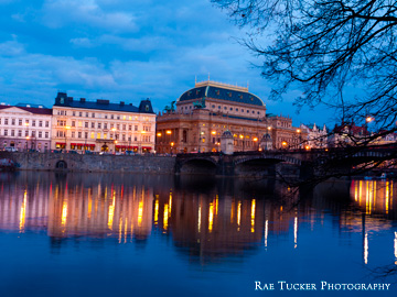 Evening over the Vltava River and the Prague Opera House in the Czech Republic.