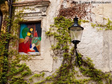 On a stone wall in Bratislava, paintings reside where windows used to.