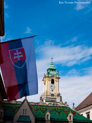 The Slovakian flag, with town hall in the background in Bratislava