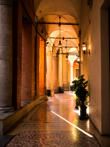 Morning light glows in a portico in Bologna, Italy