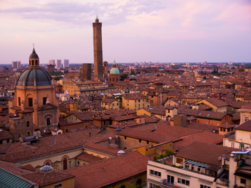 A sunset glows pink over the centre of Bologna, Italy