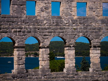 View of the Adriatic sea through the windows of the Roman arena in Pula, Croatia