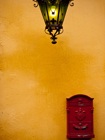 Street lantern and red mailbox in Bologna, Italy