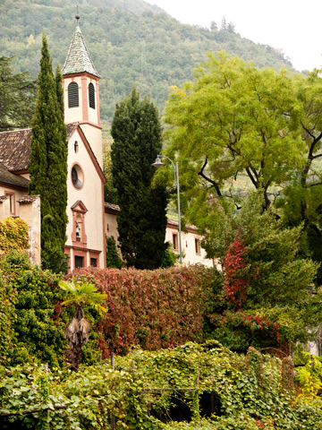 A church surrounded by autumn foliage in South Tyrol, Italy