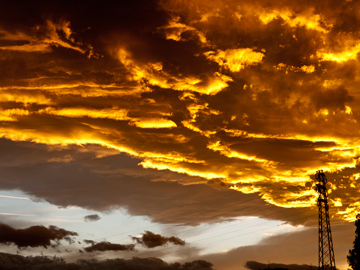 Clouds look like fire in the sky illuminated by the setting sun in Bologna, Italy