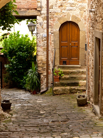 A small courtyard leads to a home in Tuscany, Italy