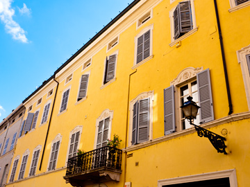 A yellow, residential building in Parma