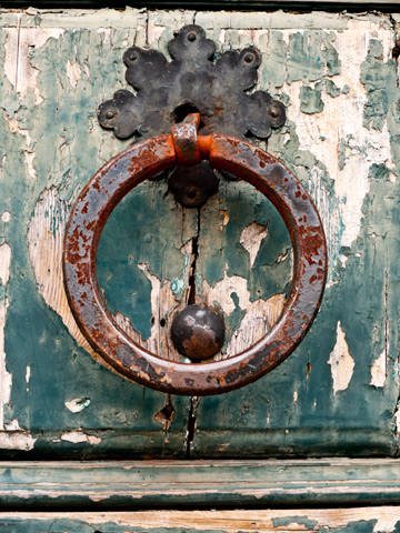 A rusted medieval door knocker in San Marino