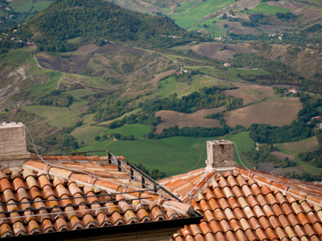 Terra cotta rooftops, with San Marino country side in the background