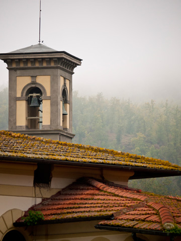 Terra cotta rooftops and a bell tower in Greve in Chianti, Italy