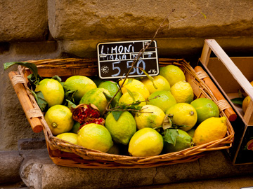 Lemons displayed in a wicker basket in Cortona, Italy