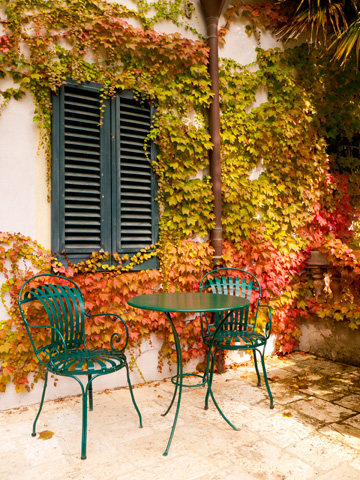 A table and chairs ready for afternoon wine on a Tuscan, autumn afternoon.