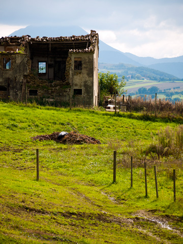 A dilapidated building on a hill in Marche, Italy
