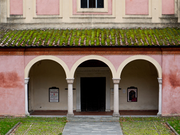 The entrance of a pink church in Emilia Romagna, Italy