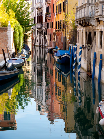 On a Sunday afternoon in November, the colors of venice are brilliantly reflected in the waters of a canal.