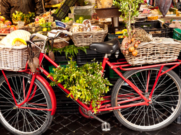 A bicycle displays produce at a market in Rome, Italy
