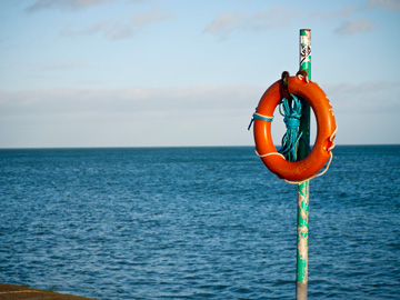 A lifesaver stands before the Irish Sea.