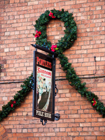 A wreath and garland decorate a brick pub in Limerick, Ireland