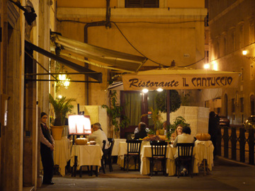 A ristorante  lit by the yellow street light of Rome, Italy
