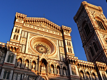 The duomo and bell tower lit by the setting sun in Florence, Italy