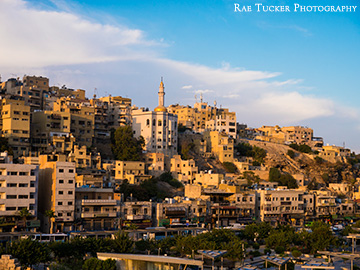The golden hue of the sun setting over Amman, Jordan